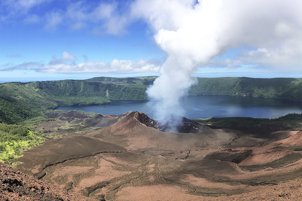 A volcano spews smokes