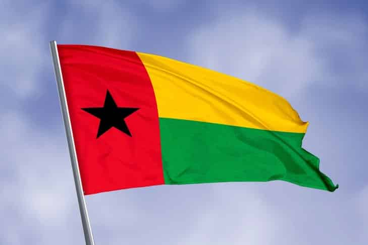 Guinea-Bissau's flag flying in the sky