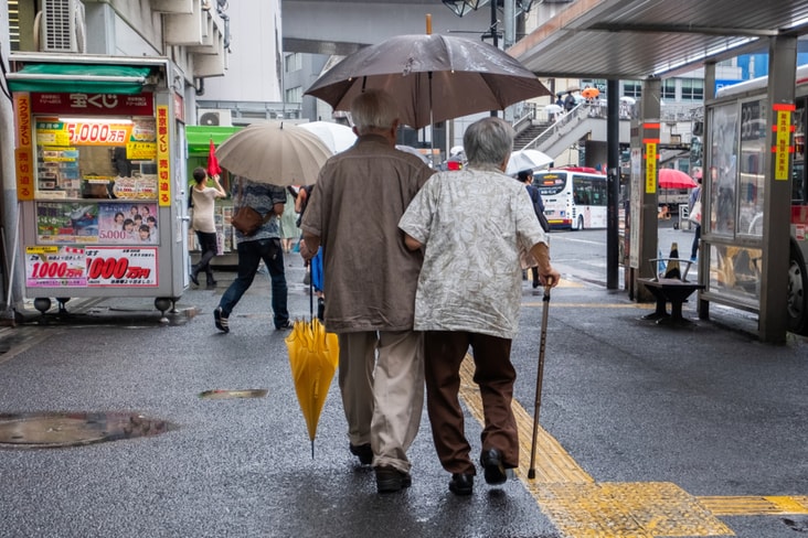 Two elderly Japanese people in a street