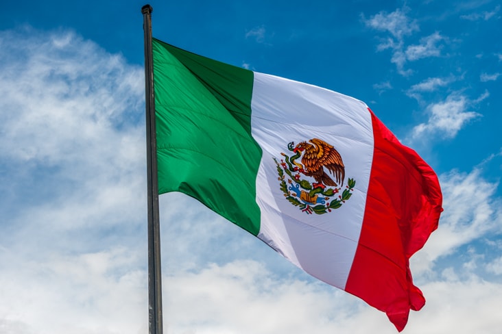 The flag of Mexico flying in the sky