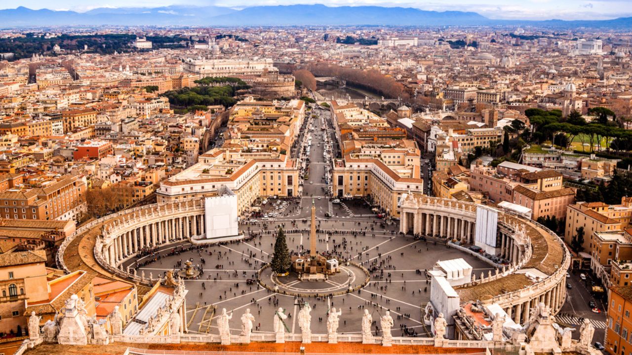 Famous Saint Peter's Square in Vatican and aerial view of the city.
